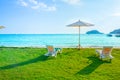 Beach chairs and beach umbrellas are on the lawn at the beach.Sea view and bright sky. Royalty Free Stock Photo