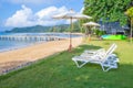 Beach chairs and beach umbrellas are on the lawn at the beach Royalty Free Stock Photo