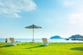 Beach chairs and beach umbrellas are on the lawn at the beach.Sea view and bright sky Royalty Free Stock Photo