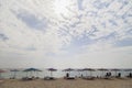 Beach chairs, umbrellas on sea sand sky and cloud background. Royalty Free Stock Photo