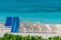 Beach Chairs on white sand shore Caribbean turquois sea