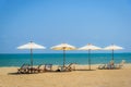 Beach chairs and white umbrella on the tropical beach Royalty Free Stock Photo