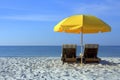 Beach Chairs with Yellow Umbrella on White Sandy Beach