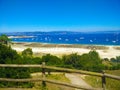 Beach of Cies Islands, in Galicia, Spain, with boats docked in f Royalty Free Stock Photo