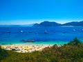 Beach of Cies Islands, in Galicia, Spain, with boats docked in f Royalty Free Stock Photo