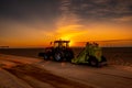 Beach cleaning at sunrise on the east coast of England. Royalty Free Stock Photo