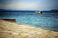 Beach and clear sea with cloudy sky and motorboat, Croatia Dalmatia Royalty Free Stock Photo