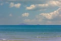 Beach with clear water with clear blue calm sea and mountains on the background and beautiful sky.Summer holiday and vacation Royalty Free Stock Photo