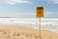 Beach closed sign standing near the ocean