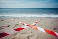 Beach closed for swimming and cordoned off with hazard warning tape.