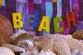 The text message is the word BEACH with seashells and striped fabric in bright colors. Royalty Free Stock Photo