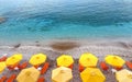 Beach with colourful sunbeds and umbrellas by clear turquoise blue waters of Mediterranean sea on sunny hot summer day Royalty Free Stock Photo