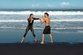 Beach. Couple Boxing Full-Length Portrait. Shirtless Man Training Sexy Woman To Punch. Partner Workout On Vacation. Royalty Free Stock Photo