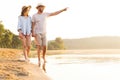 Beach couple walking on romantic travel honeymoon vacation summer. Royalty Free Stock Photo