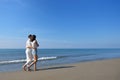 Beach couple walking on romantic travel honeymoon vacation summer holidays romance. Royalty Free Stock Photo