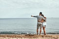 Beach couple walking on romantic travel honeymoon vacation summer holidays romance. Back view of casual happy lovers in full body Royalty Free Stock Photo