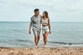 Beach couple walking on romantic travel honeymoon vacation. Summer holidays romance