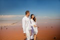 Beach couple walking on romantic travel honeymoon vacation summer vacation romance.