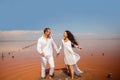 Beach couple walking on romantic travel honeymoon vacation summer vacation romance.