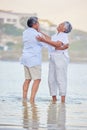 Beach dance, senior couple and comic man and woman standing in sea or ocean water and hugging at sunset. Happy, smile Royalty Free Stock Photo