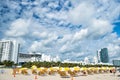 Beach with deck chairs under yellow umbrellas