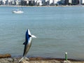 Beach, with Dolphin statue, waves, city in the background, located in VitÃÂ³ria.