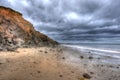 Beach, Dramatic Sky, Stormy Clouds, showing coastal erosion of cliffs Royalty Free Stock Photo