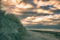 on the beach with dune on the Baltic Sea. Cloudy sky. Waves meet sand. Landscape