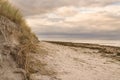 on the beach with dune on the Baltic Sea. Cloudy sky. Waves meet sand. Landscape