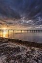 Beach Dune pier under fantastic sunset clouds with long exposure over Baltic sea, Schonberg, Germany