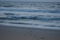 Sunrise on the ocean, white sky, and sand