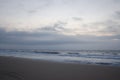 Sunrise on the ocean, white sky, and sand