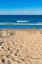 Beach entrance with sand and ocean on sunny day Royalty Free Stock Photo