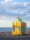 Beach equipment folded. Sunbeds on top of each other. Concept of the end of the beach season. Autumn at sea