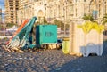 Beach equipment folded. Sunbeds on top of each other. Concept of the end of the beach season. Autumn at sea. Sunset