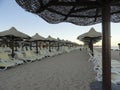 Beach Equipped with sunbeds and umbrellas - in the evening, at sunset