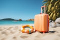 Beach essentials Suitcase and inflatable ring on a sandy shore