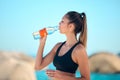 Beach, exercise and woman drinking water, health and training with stress relief, relax and break. Female person, girl Royalty Free Stock Photo