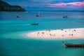 Beach that extends into the sea Looking out to see the island And blue sky There are many boats floating in the emerald green Royalty Free Stock Photo