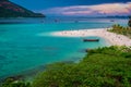 : Beach that extends into the sea Looking out to see the island And blue sky There are many boats floating in the emerald green se Royalty Free Stock Photo