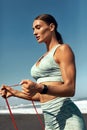 Beach. Fitness Girl Stretching With Resistance Band Outdoor. Sexy Woman In Sporty Outfit Doing Flexibility Exercise.