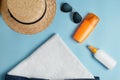 Beach flat lay accessories. Sun hat,  towel,cream, sunscreen bottle, sun cream, lotion bottle, seashells Royalty Free Stock Photo