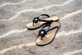 Beach flip-flops on a  sand. Texture of light sand. The concept of a beach holiday. Summer concept. Flat lay, top view Royalty Free Stock Photo