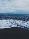 Beach foam on a black sand beach