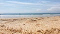 a beach with footprints in the sand and a boat in the distance, bali nusa penida