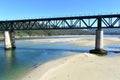 Beach with forest and train bridge over Sor coastal river. O Barqueiro, A Coruna Province, Galicia, Spain. Royalty Free Stock Photo