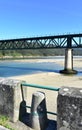 Beach with forest and two train bridges, old one used as a promenade. Sor River, O Barqueiro, A Coruna Province, Galicia, Spain. Royalty Free Stock Photo