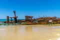 the beach of fraser island lies the skeleton of a washed-up shipwreck in fine weather Royalty Free Stock Photo