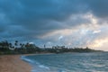 The beach front at Kapaa Shores on Kauai where Palm trees are swaying in the wind of Pacific Royalty Free Stock Photo