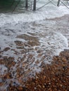 beach front stone beach waves drifting Royalty Free Stock Photo